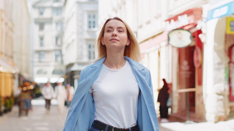 Woman walking confidently through the city after regaining her emotional balance